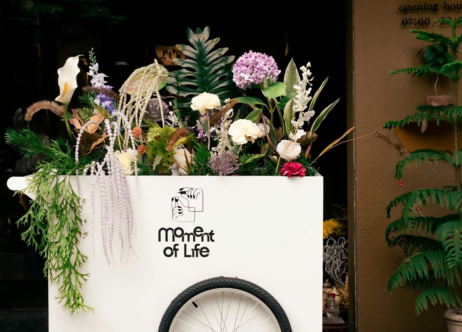 A bicycle cart filled with flowers
