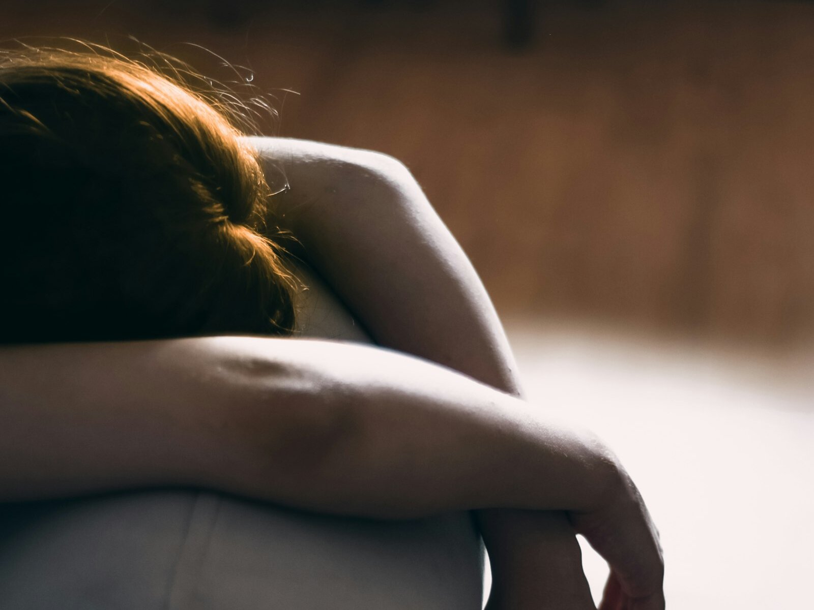 A person resting on a sofa in a living room