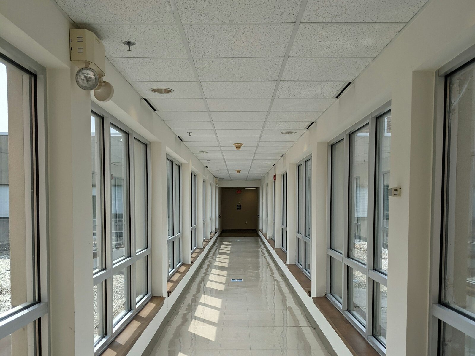A sunlit corridor with glass windows