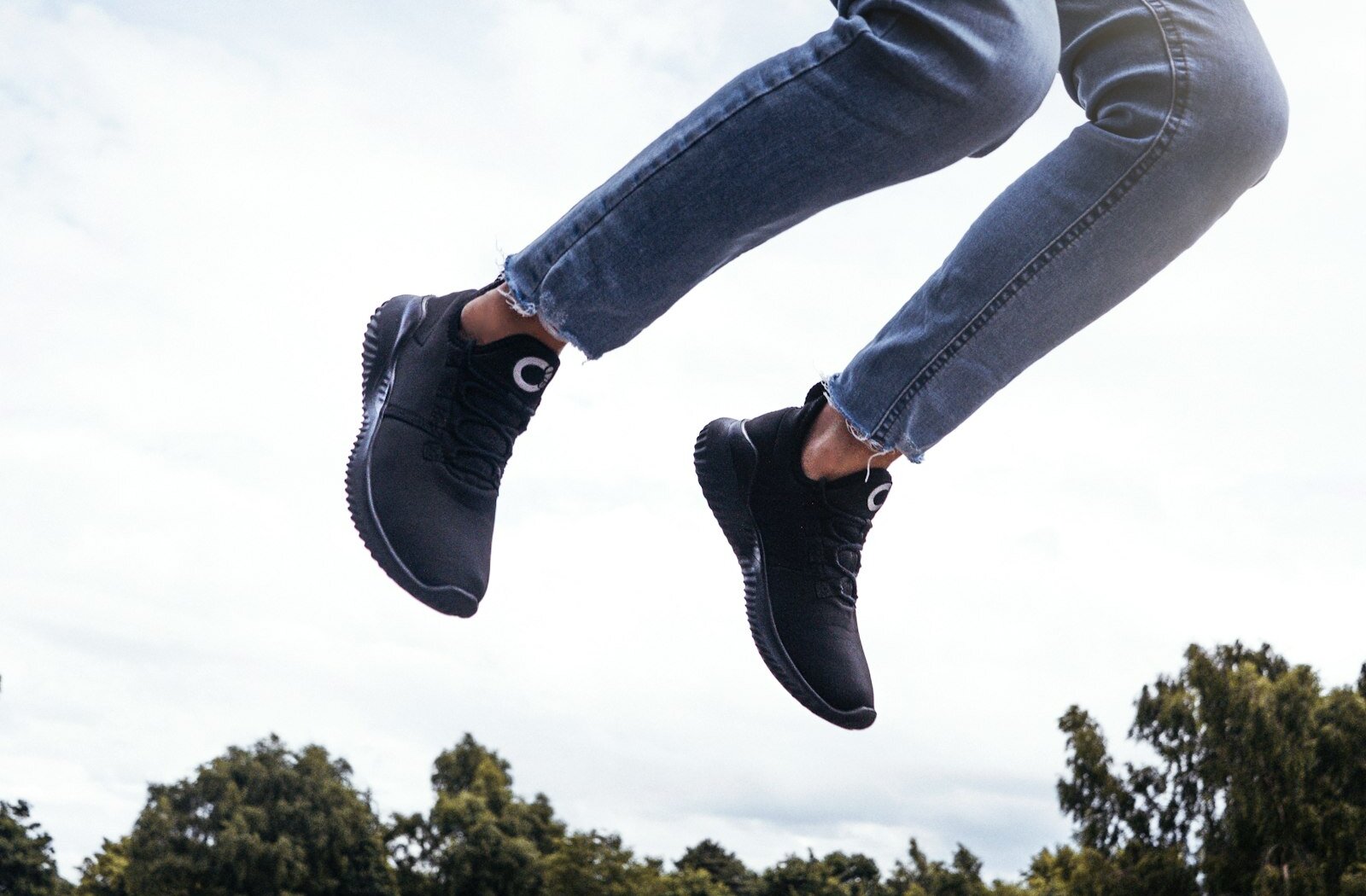 Legs in black sneakers jumping in the air
